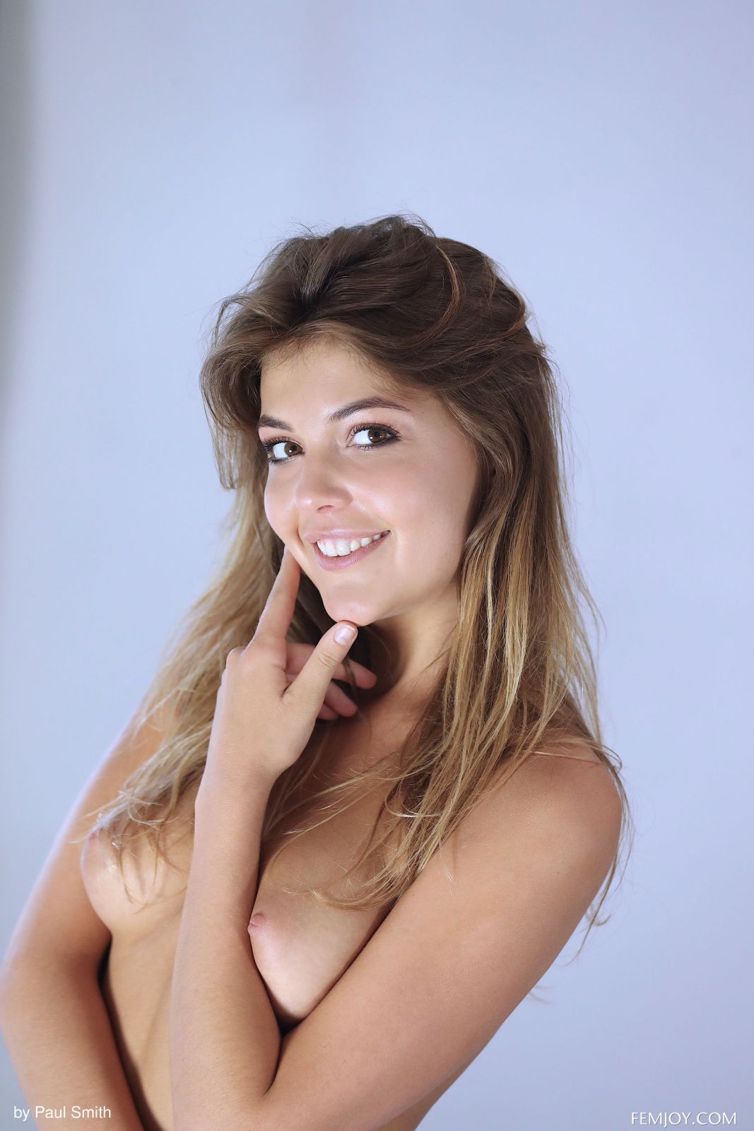 Lindsey T takes off her pink shirt and panties on the bed