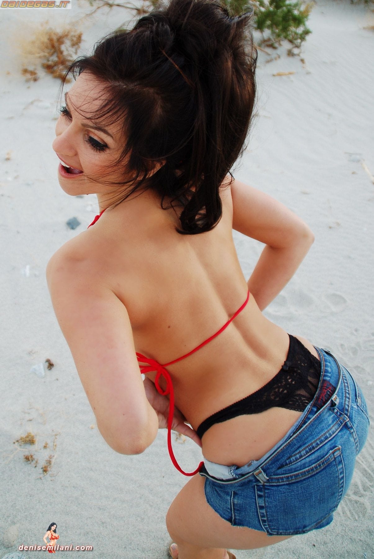 Denise Milani posing at windmills