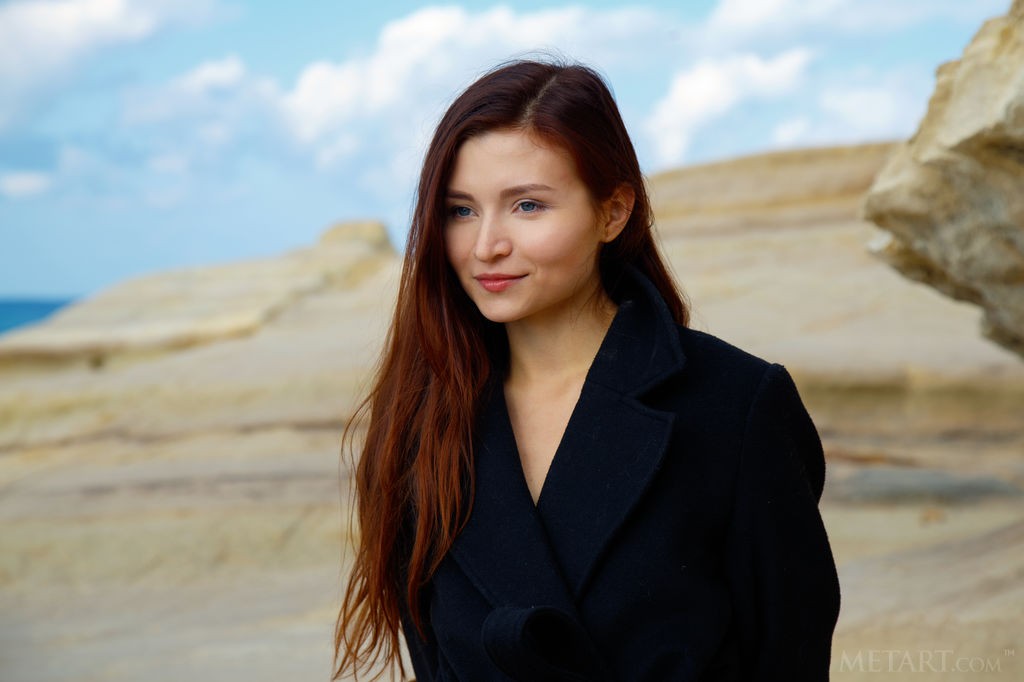 Berenice - Subtle red head teen beauty taking off her coat on a beach