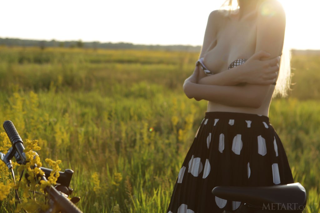 Kira W - Blonde cutie rides her bicycle half-naked in the field