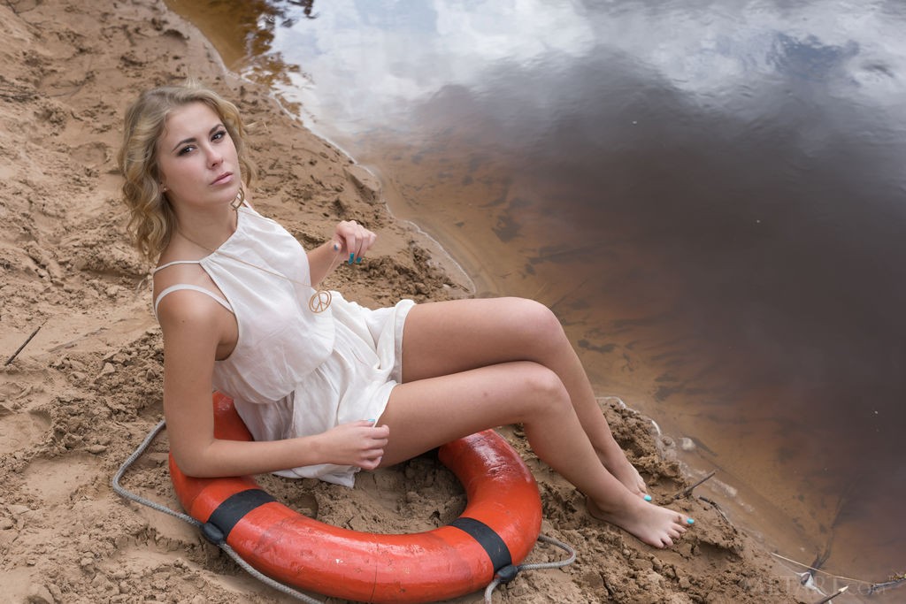 Casey - Skinny babe plays with a life preserver on a sandy beach