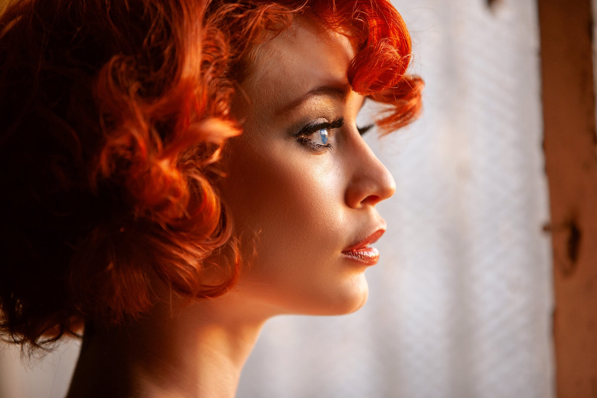 Marvelous redhead Justine Joli posing nude by the window